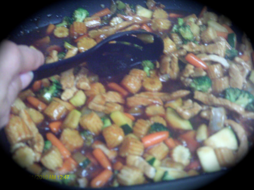 Stir the stir-fry to mix in the sauce.