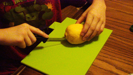 Carefully cut the lemon in half.