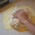Roll pizza dough in the corn meal and sea salt