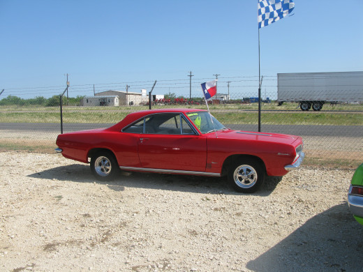 Here's a nice little Pony car, a Plymouth Barracuda.  Bright red with Cragar S/S rims.  That's guaranteed to get you a ticket if you push it to the limit.