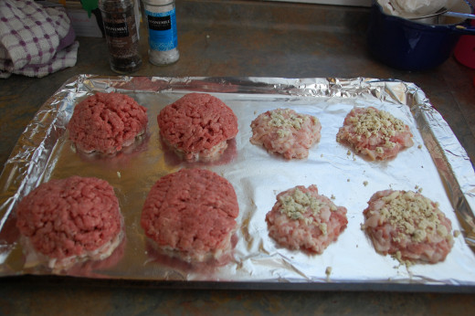 Burger patties on top of cheese and bacon patties