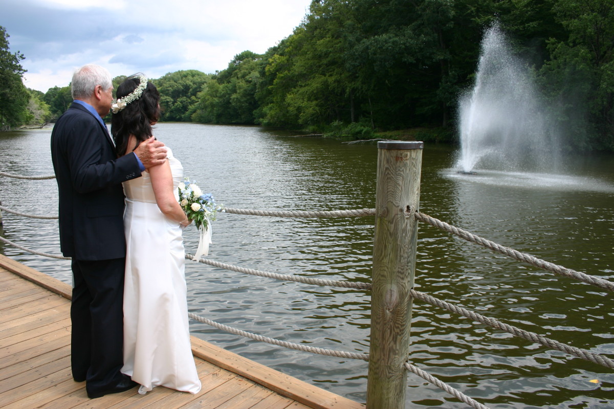 The fountain in the river provides a beautiful backdrop for pictures.