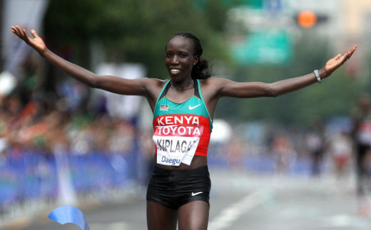 Edna Kiplagat of Kenya celebrates winning the women's world marathon title in Daegu, South Korea 2011.