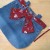 Position belt/bow and hand stitch to secure it in place. Position belt/bow and hand stitch to secure it in place.