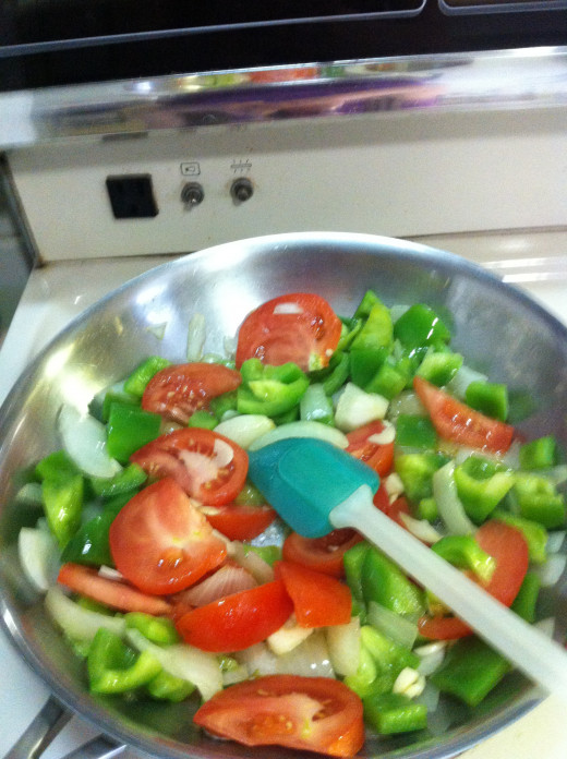 Cook all ingredients till tomato is cooked down to almost a liquid state.