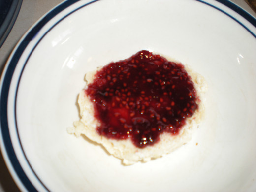 Raspberry syrup spread on top of biscuit