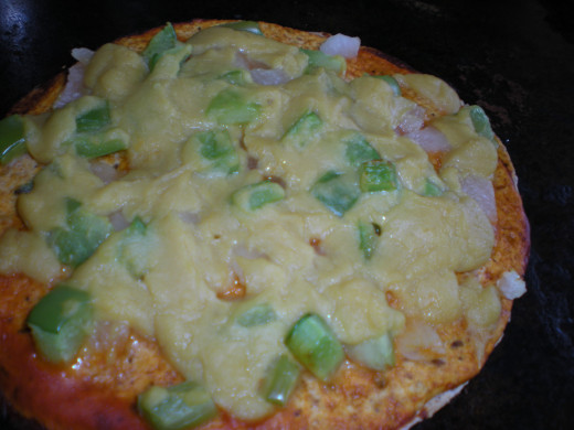 Cooked tortilla pizza with nutritional yeast cheese