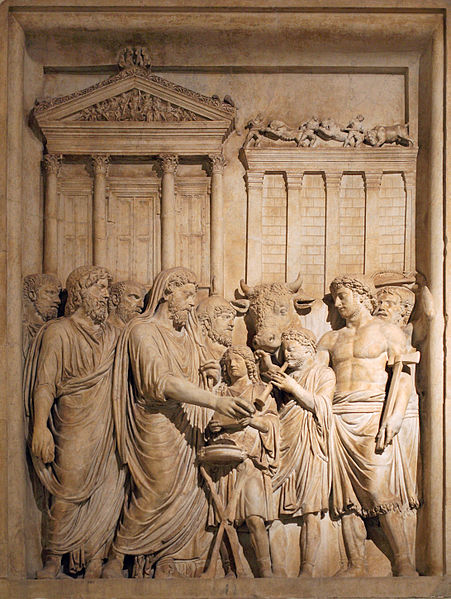 Emperor Marcus Aurelius (161-180 AD) and the Imperial family offer sacrifice in gratitude for success against Germanic tribes. In the backgrounds stands the Temple of Jupiter on the Capitolium.  Bas-relief from the Arch of Marcus Aurelius, Rome.