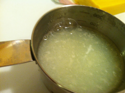 Finished product homemade laundry detergent has a slightly cloudy, egg-drop soup consistency.