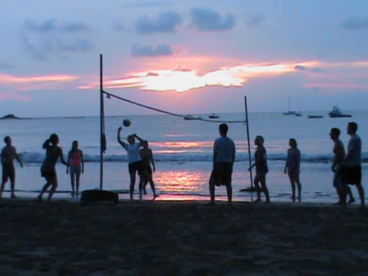 Beach volleyball at sunset on Playa Tamarindo.  People often play soccer on the beach as well.  Boats tow behind floats that hold about 8 people on many beaches as well.