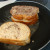 After dipping the sandwich in the egg mixture, grill it on each side in a pan with the melted butter. After dipping the sandwich in the egg mixture, grill it on each side in a pan with the melted butter.