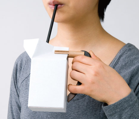 Photo of Girl Drinking from Milk Carton with Handle