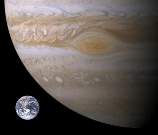 A Voyager photograph of the Great Red Spot on Jupiter with Earth superimposed for comparison.