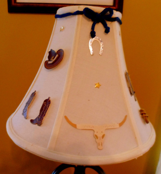 Easy lampshade made with cowboy themed scrapbook stickers.