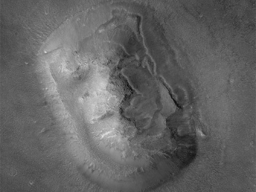 Surprise! It's the so-called "Face on Mars" photographed with the sunlight at a different angle. Sorry, conspiracy theorists; it's just a pile of rock. 
