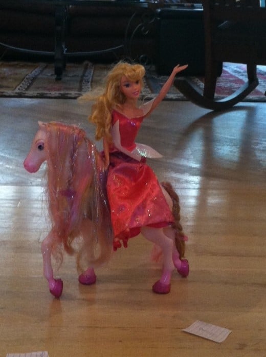 Piink "Star Princess" riding her pink pony and waving at the crowd.