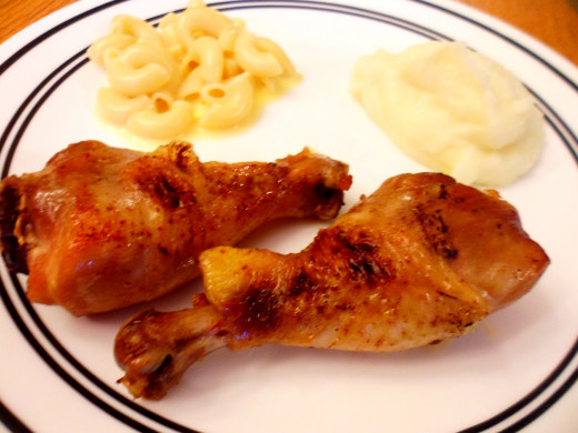 Coffee-brined chicken legs served with macaroni and cheese and mashed potatoes.