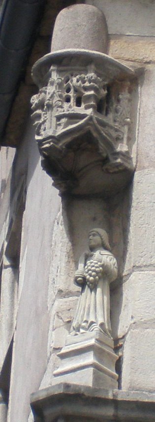 Carving on a house: the patron saint of the vine with a pruning knife.