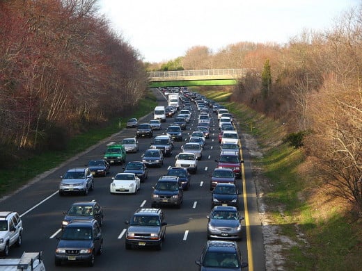 Heavy traffic slowed to a crawl on a parkway.