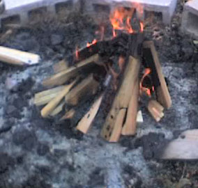 A simple bonfire in a pit surrounded by cinder blocks