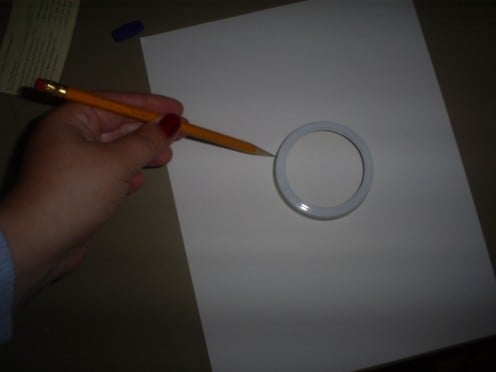 Trace around the outside of a canning jar lead for the larger circle.
