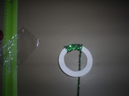 Use another green pipe cleaner to wrap around the cardstock Christmas wreath template.