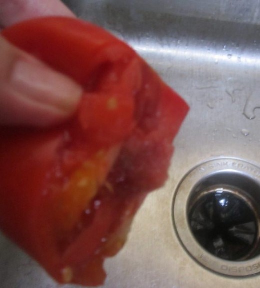 Cut tomato in half and squeeze out much of excess juice. 