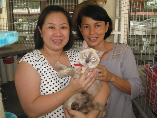 Sabrina posing with a friend cum animal rescue with her adopted cat from Furry Friends Farm