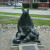 A cute mother bear statue in a garden near main street. A cute mother bear statue in a garden near main street.