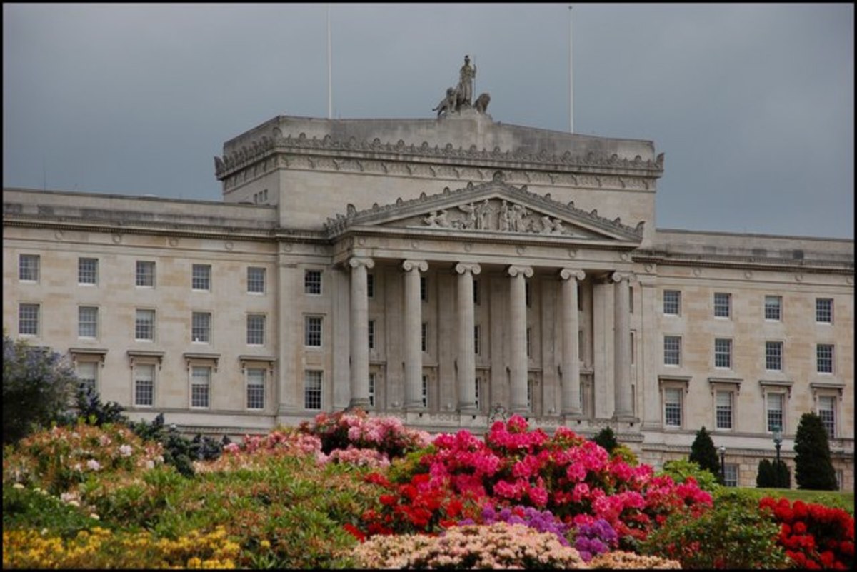 Parliament Buildings, Stormont, Belfast. Part of the front of the building with the main entrance (under the portico) hidden by the rhododendrons.