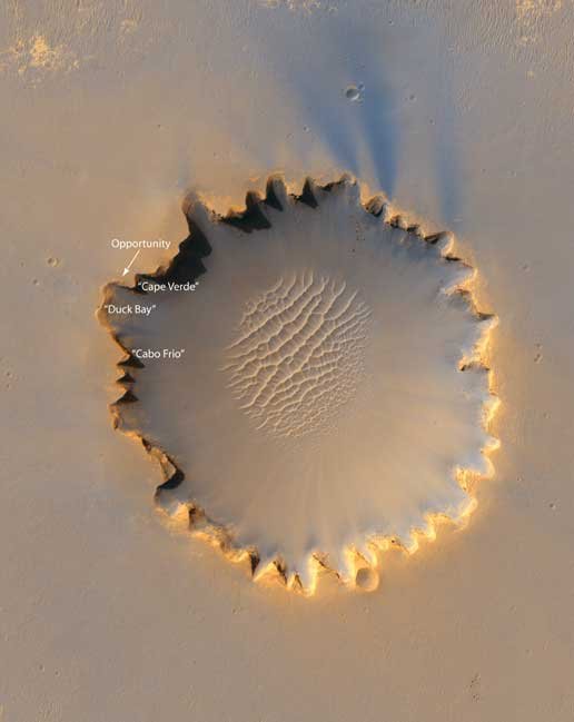 An impact crater 800m in diameter near the equator of Mars taken by the High Resolution Imaging Science Experiment on the Mars Orbiter. You can see the rover Opportunity labelled.