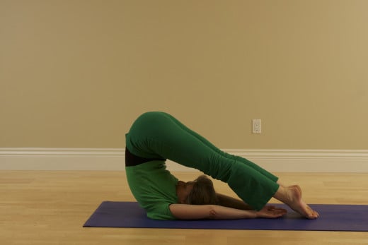 Plough, or Halasana, relaxes the back, stretches the backs of the legs, and strengthens the abdominal muscles.