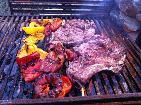 Rare steaks and grilled peppers on the grill