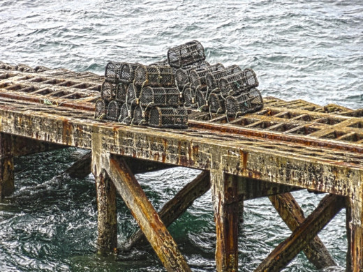 Lobster pots stacked on the old disused lifeboat launch jetty at Lizard Point.