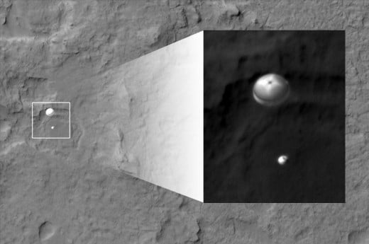 HiRISE camera of NASA's Mars Reconnaissance Orbiter, an older spacecraft studying Mars from space, pointed at the spot JPL hoped Curiosity would be visible. BINGO! The camera caught a photo of the descent stage! (from Aug 6, 9AM press conference)