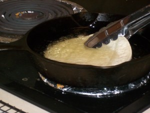 Dip the tortillas in oil for a few seconds.