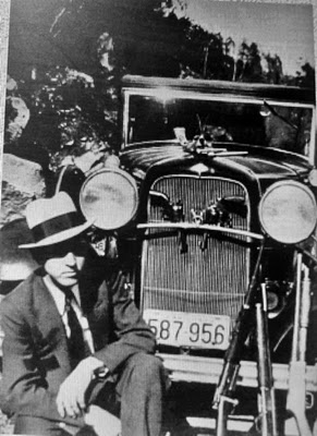 Gangster Clyde Barrow with a Model A Ford car. Barrow and his accomplice were named "Bonnie and Clyde".