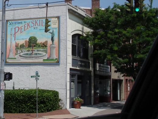 This is a photo of Peekskill.  The postage stamp metallic poster on the side of this building gives me the feeling of the ocean somewhere. Also, 