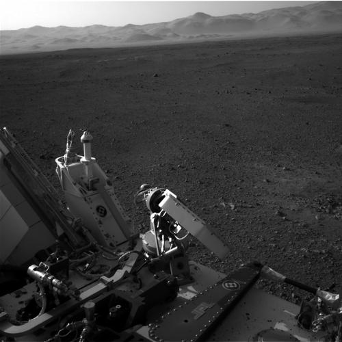 High-gain antenna in foreground, rim of Gale Crater in background.