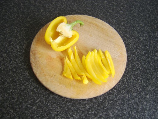 Slicing yellow bell pepper for watercress salad