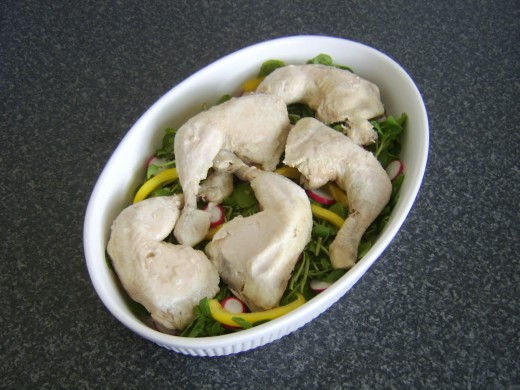 Chicken legs are laid on watercress salad