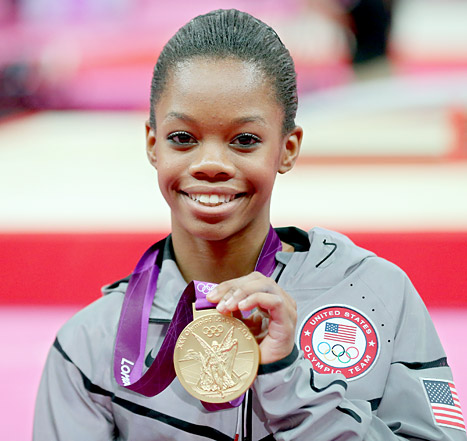 Gabrielle Douglas proudly showing her Olympic Gold Medal for Individual Gynastics