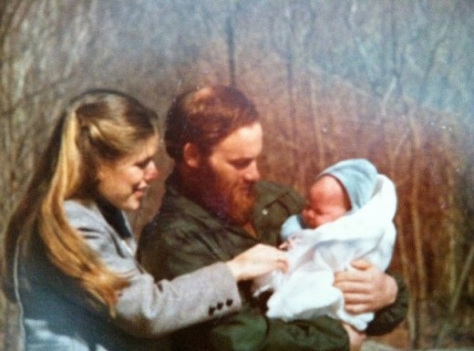 My birth mother and adoptive father holding me as a newborn.