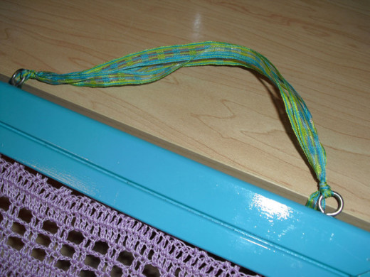 Add ribbon, string, or other material as a decorative element to hang your frame from.