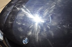 Here you can see really bad swirls, marring and buffer halo marks (holograms) on this beautiful BMW's black paint.  This is what you do not want to do when washing your car!