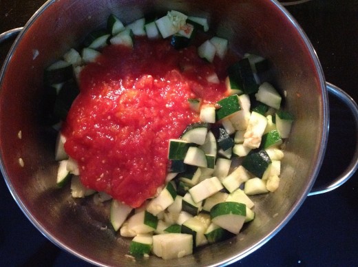 After you sauté the zucchini, add the chopped tomatoes.