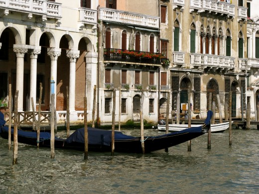 A gondola docked between traditional posts.