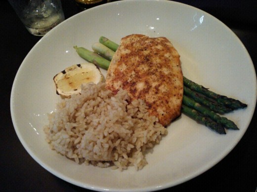 My husband's grilled Norwegian Salmon served with rice on a bed of asparagus was a hit!