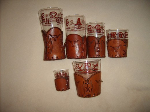 Western-themed glasses with decorative leather holders