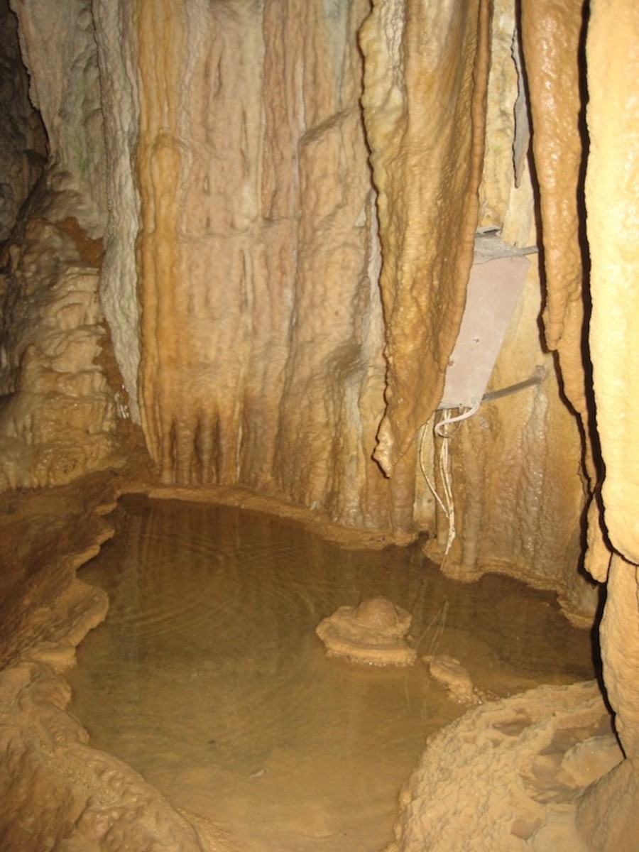 An underground pool of water that drips from the stalactites in the Waitomo Caves.